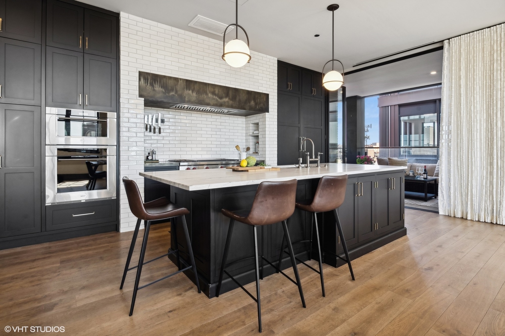 1109 West Washington Boulevard, Unit 6D Chicago, IL 60607 - Photo 16 of 41 a kitchen with stainless steel appliances kitchen island granite countertop a dining table chairs and white cabinets
