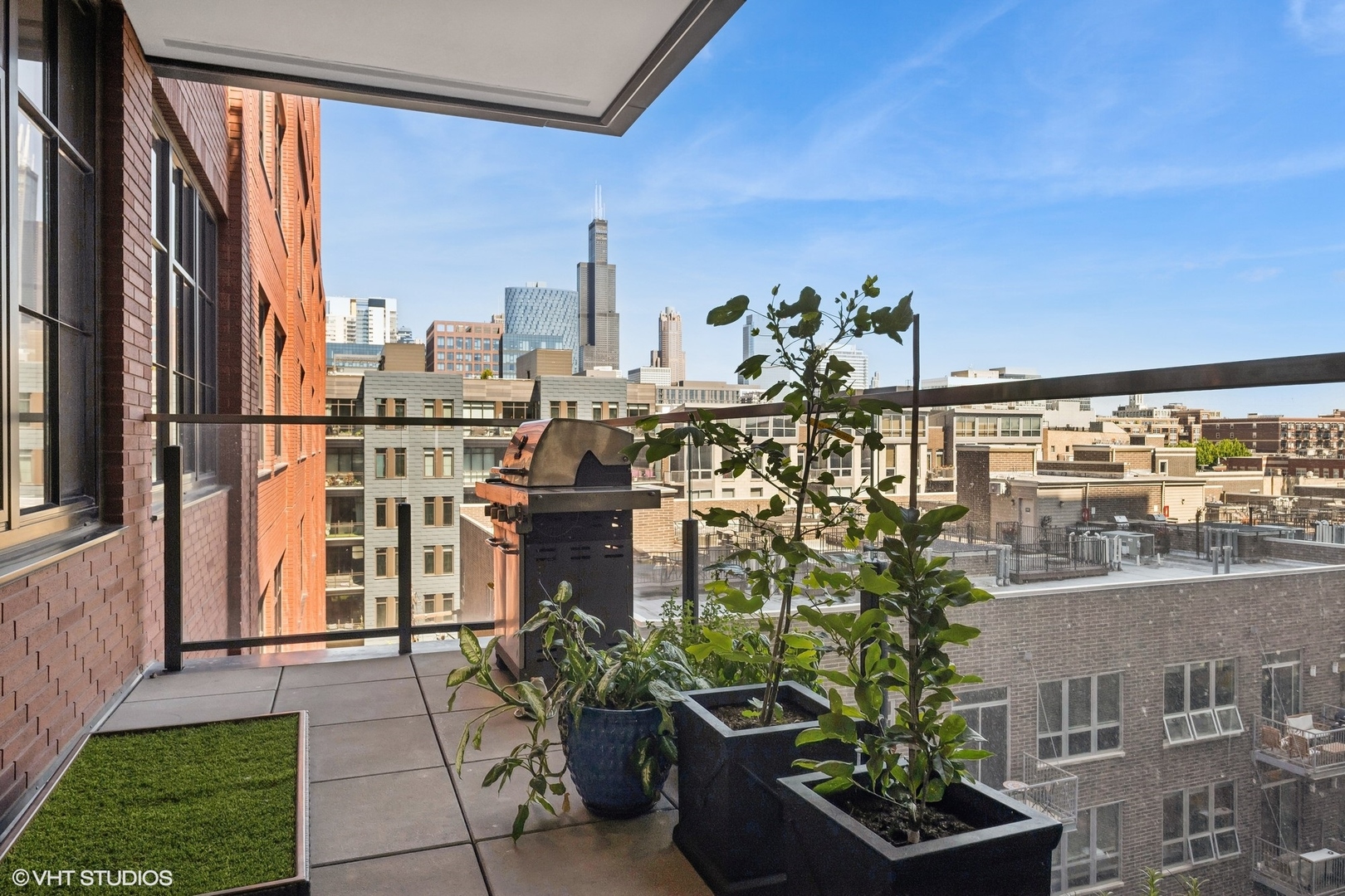 1109 West Washington Boulevard, Unit 6D Chicago, IL 60607 - Photo 20 of 41 a view of a balcony with chairs and a potted plant