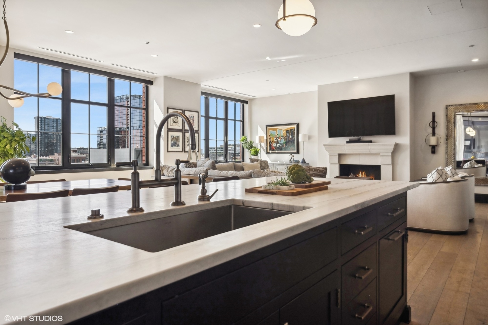 1109 West Washington Boulevard, Unit 6D Chicago, IL 60607 - Photo 21 of 41 a large kitchen with granite countertop a sink and a stove top oven with wooden floor