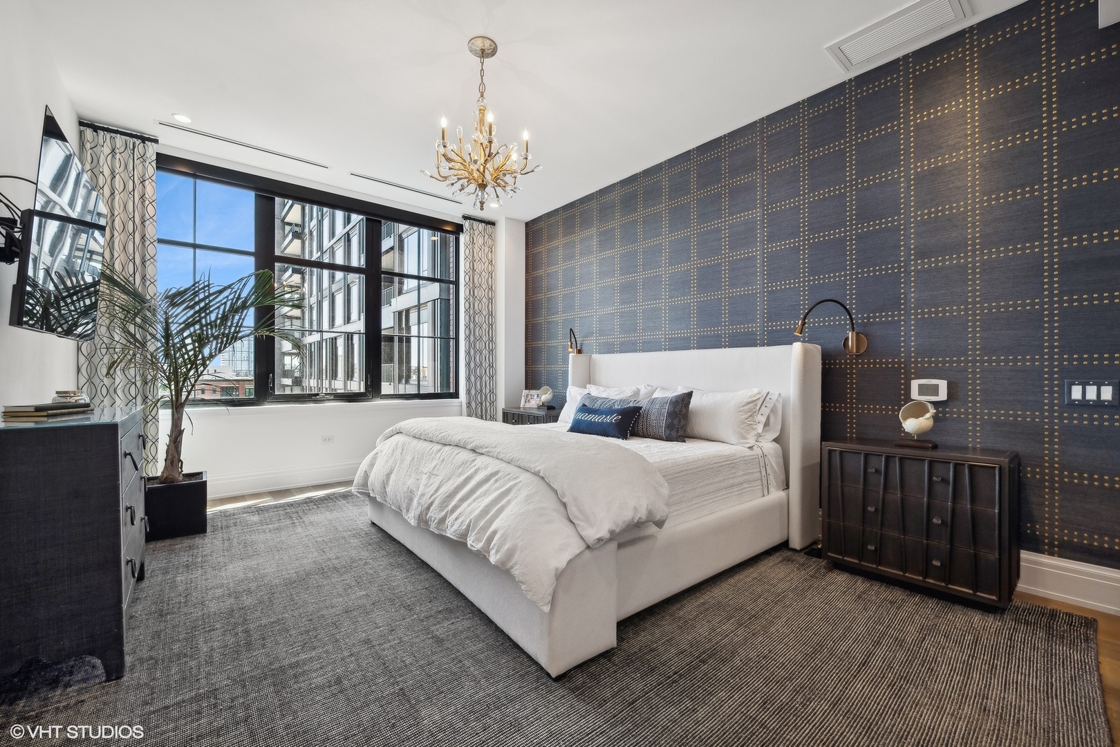 1109 West Washington Boulevard, Unit 6D Chicago, IL 60607 - Photo 27 of 41 a spacious bedroom with a bed and a chandelier