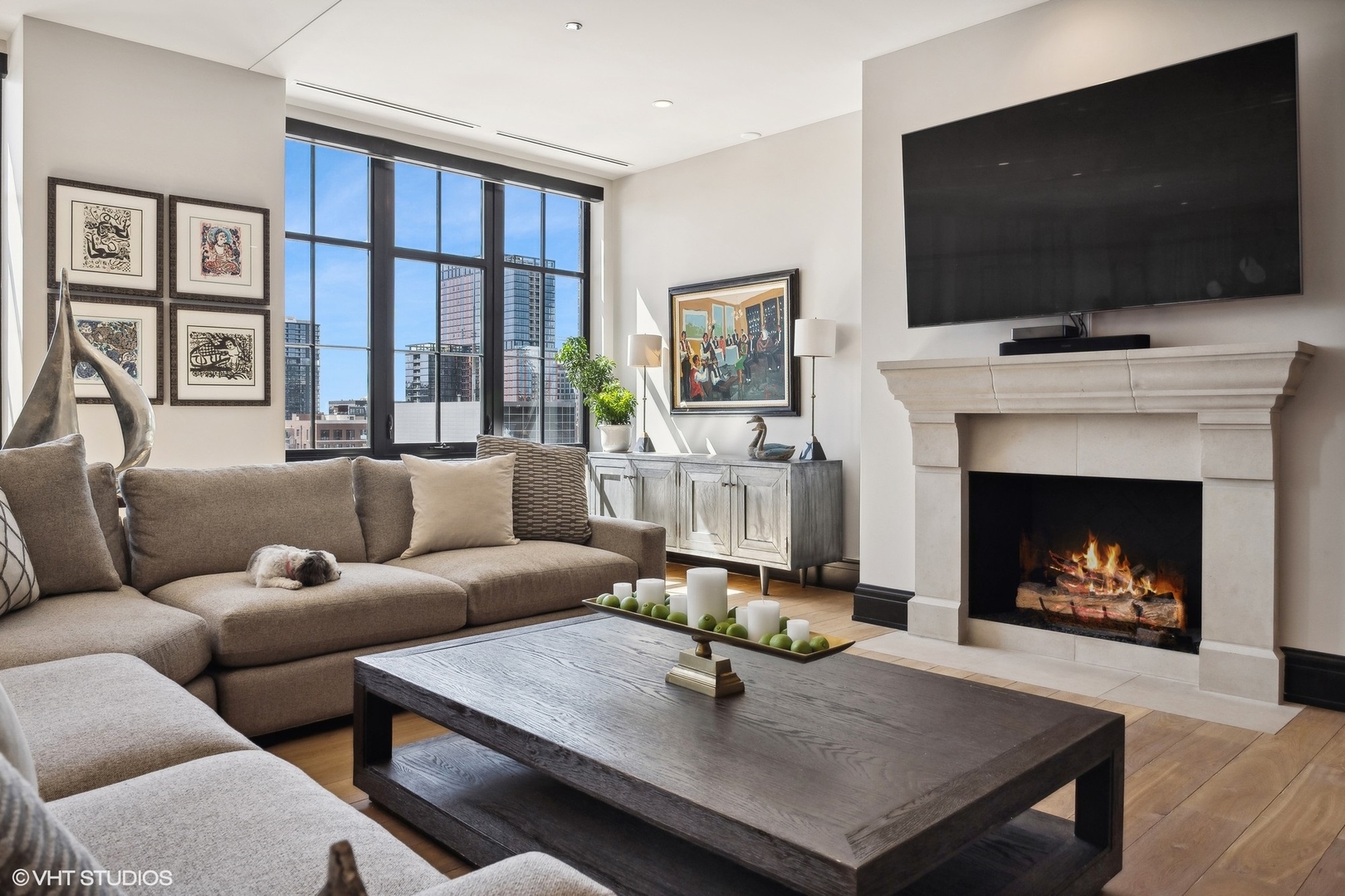 1109 West Washington Boulevard, Unit 6D Chicago, IL 60607 - Photo 6 of 41 a living room with furniture a flat screen tv and a fireplace