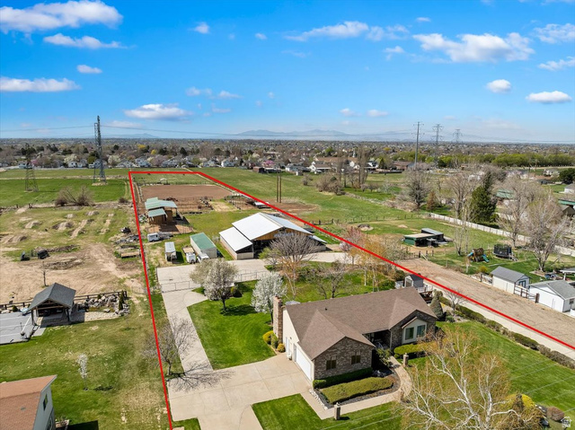 5321 South 3100th Street West Roy, UT 84067 - Photo 62 of 64 Expansive residential property featuring a single-story home with a brick and siding exterior and an attached two-car garage