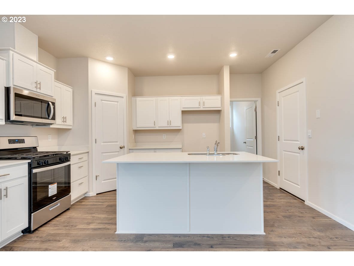 2655 26th Loop Springfield, OR 97477 - Photo 9 of 20 a kitchen with stainless steel appliances a sink stove top oven and refrigerator
