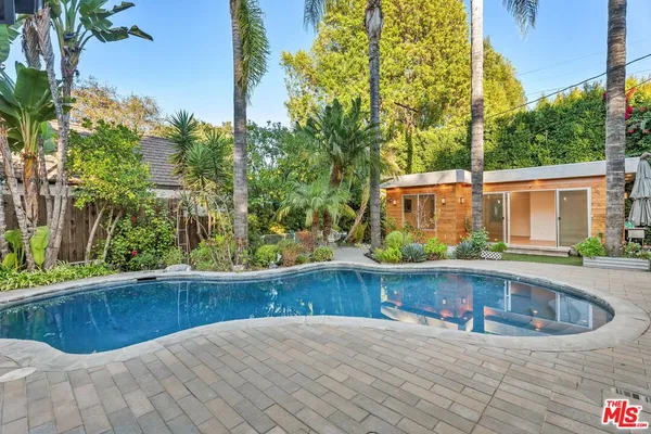 a view of a house with pool and yard