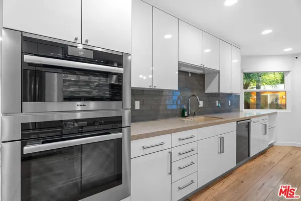 a kitchen with stainless steel appliances a stove sink and microwave