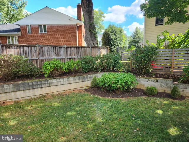 a front view of a house with a garden and plants