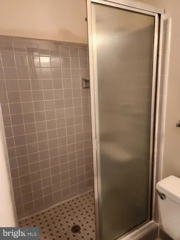 a bathroom with a glass door shower