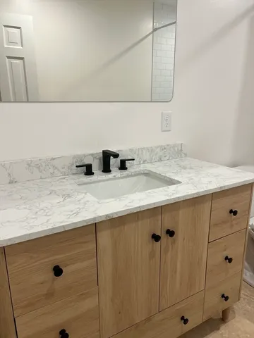 a bathroom with a sink and vanity
