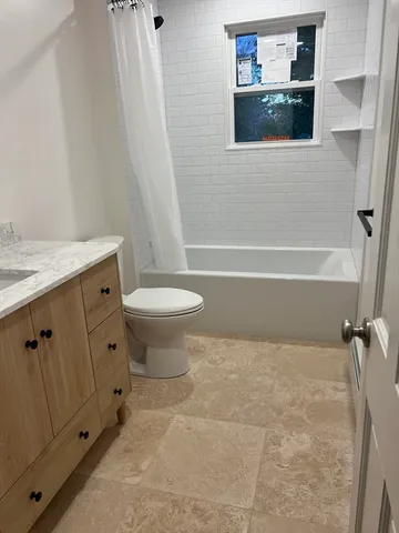 a bathroom with a toilet a sink and bathtub