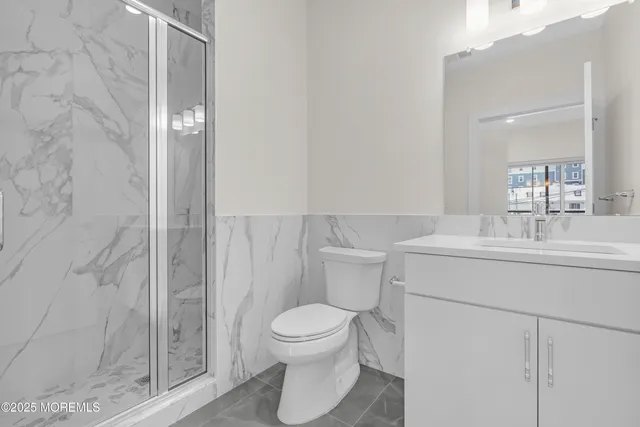 a bathroom with a toilet a sink and shower