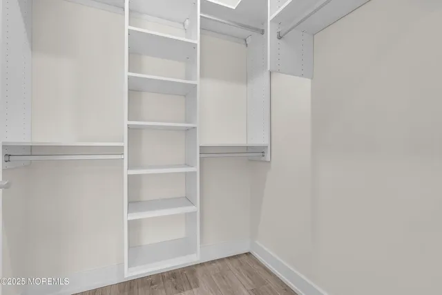 a view of walk in closet with empty racks