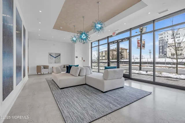 a large bed sitting in a room next to a chandelier