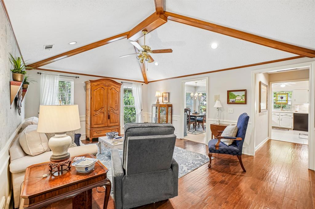 12929 Jasoncrest Trail Dallas, TX 75243 - Photo 27 of 38 Living area featuring vaulted ceilings with exposed wood beams, recessed lighting, wood-finish flooring, and multiple window exposures