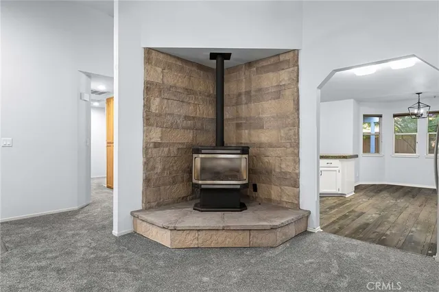 a kitchen with granite countertop white cabinets and stainless steel appliances
