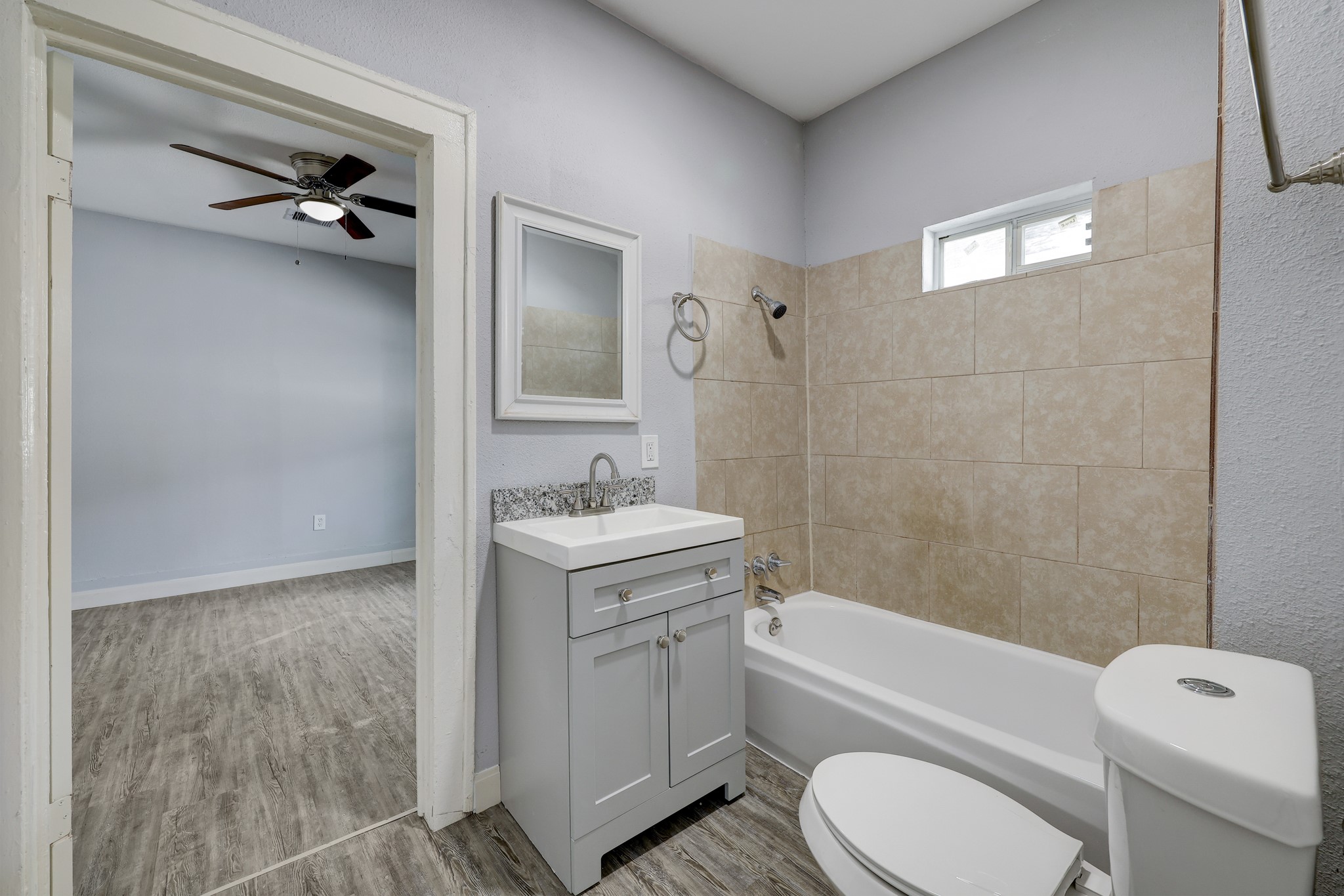 4224 Marina Street Houston, TX 77007 - Photo 11 of 13 a bathroom with a granite countertop toilet sink and mirror