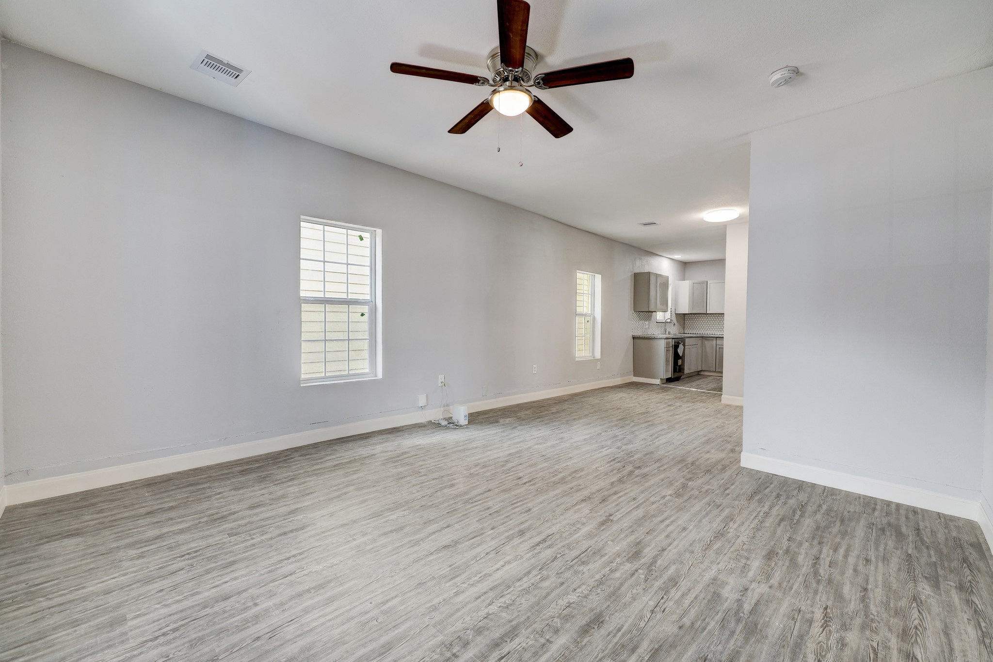 4224 Marina Street Houston, TX 77007 - Photo 4 of 13 wooden floor in an empty room with a window