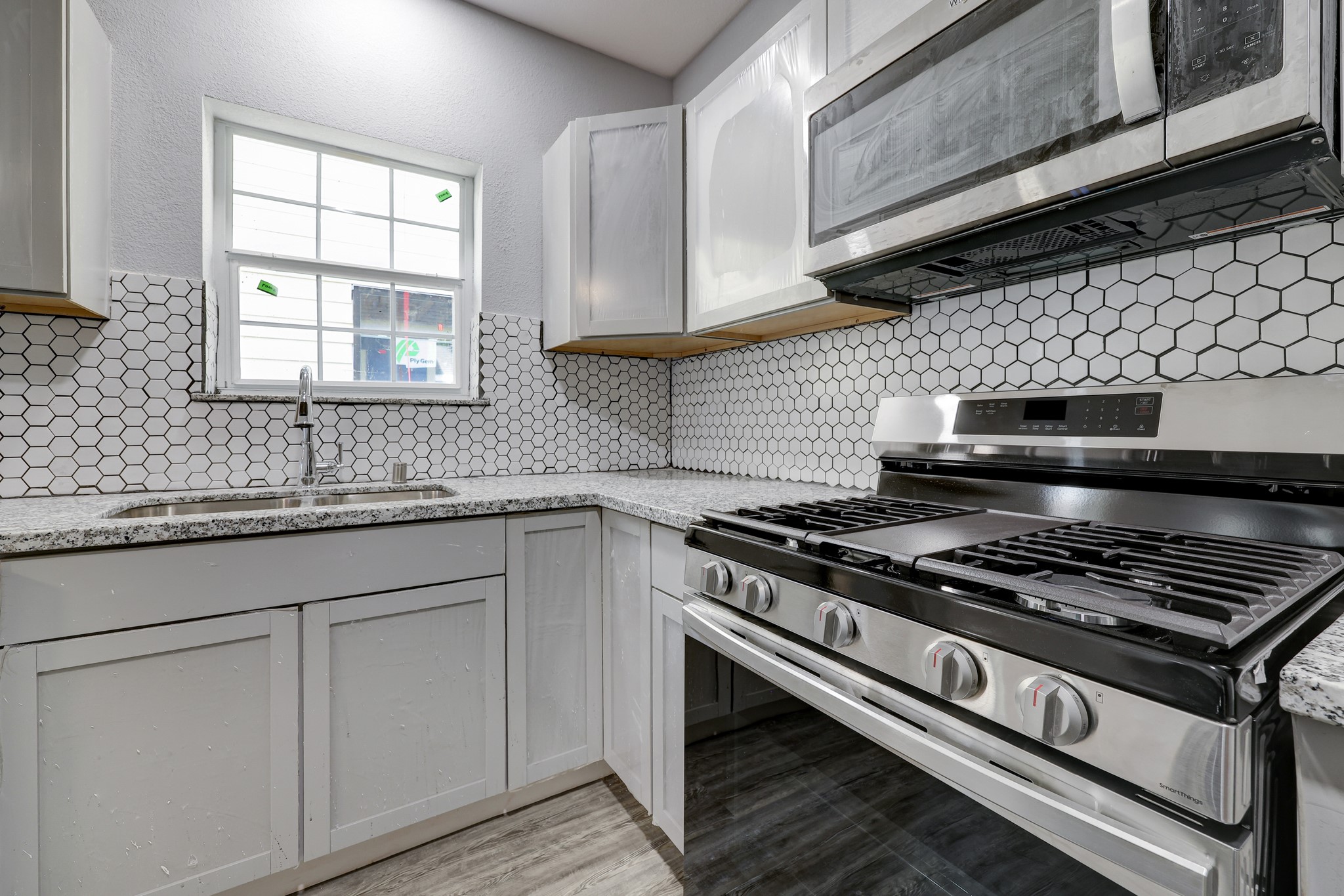 4224 Marina Street Houston, TX 77007 - Photo 6 of 13 a kitchen with granite countertop a stove and a sink