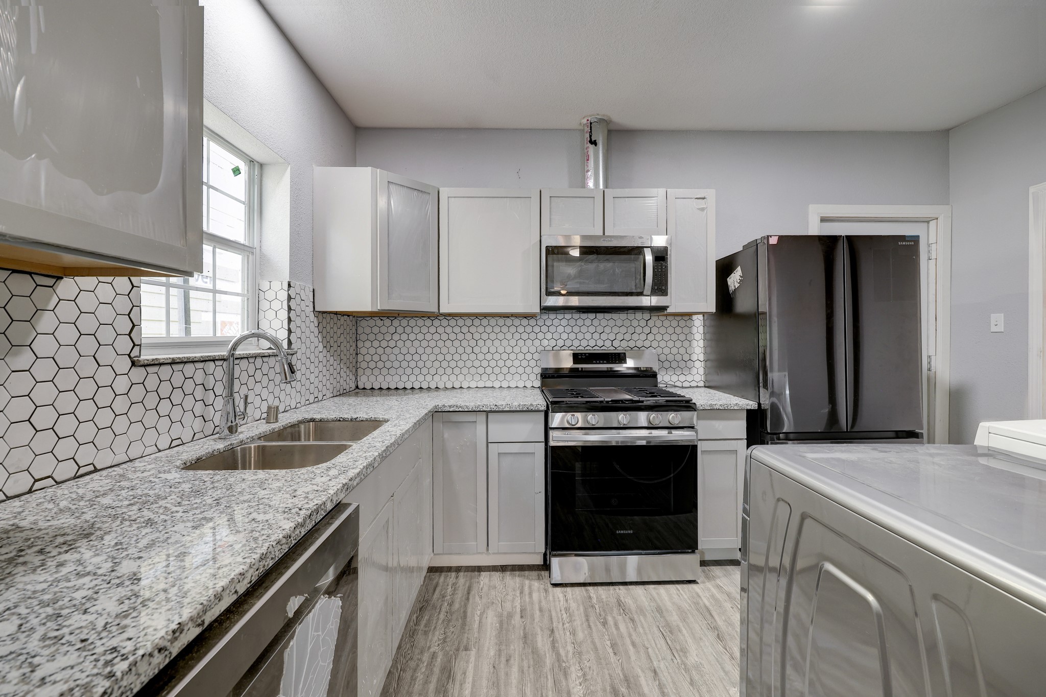 4224 Marina Street Houston, TX 77007 - Photo 7 of 13 a kitchen with stainless steel appliances granite countertop a sink stove and refrigerator