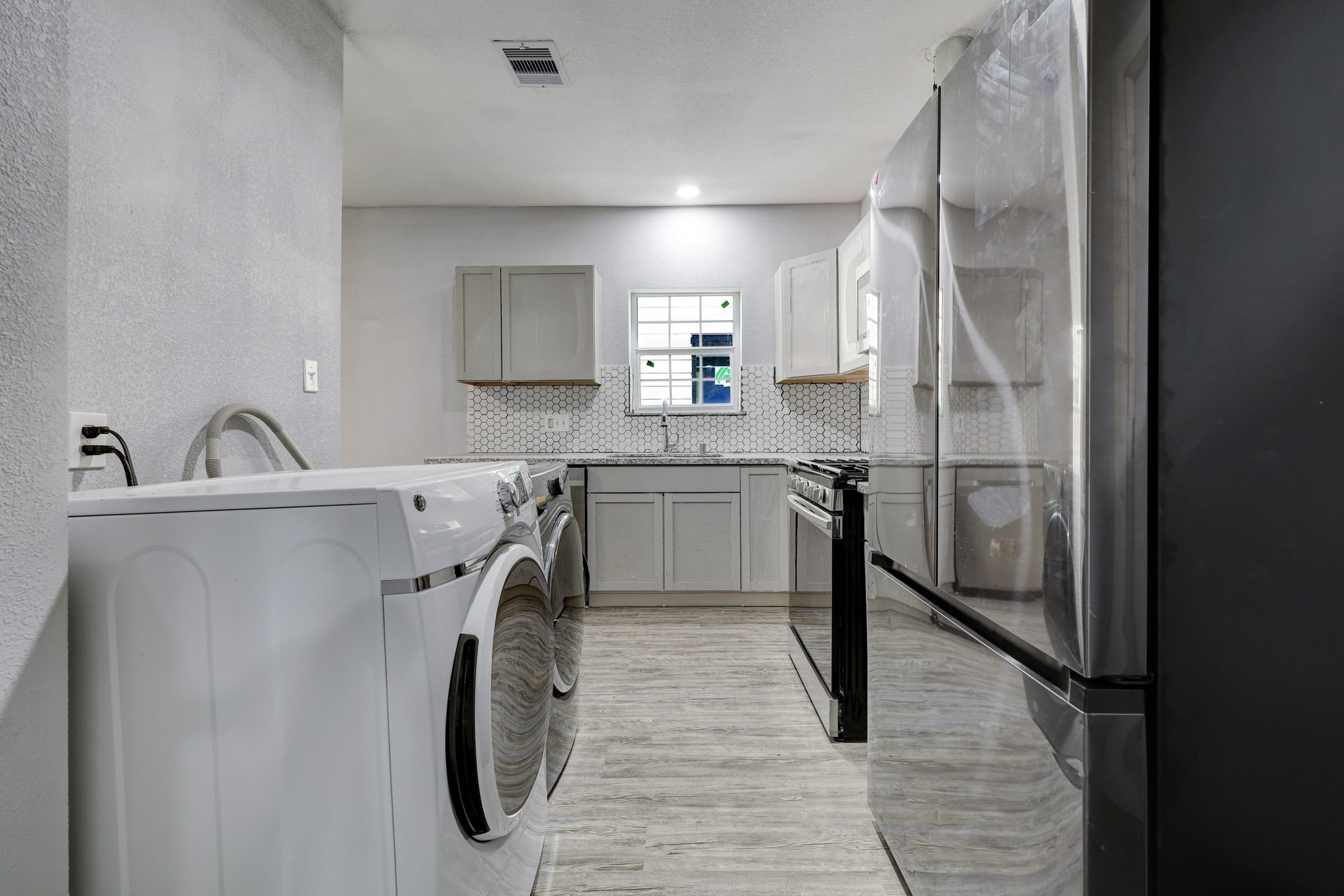 4224 Marina Street Houston, TX 77007 - Photo 8 of 13 a kitchen with stainless steel appliances granite countertop a sink a stove and a refrigerator