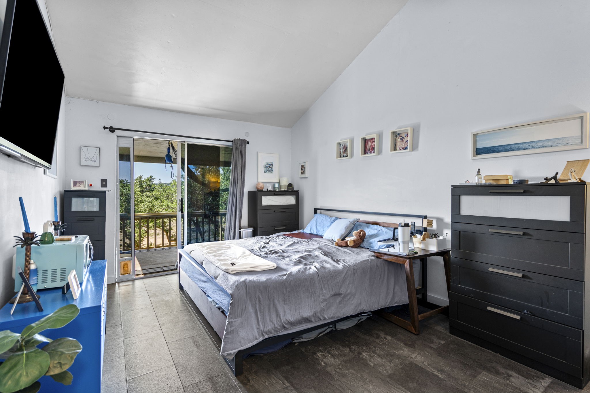 269 Venture Boulevard South Leander, TX 78645 - Photo 8 of 13 a bedroom with a bed and a flat tv screen