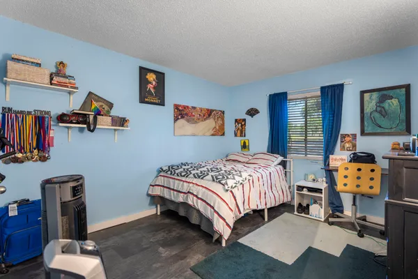 a bedroom with a bed and dresser