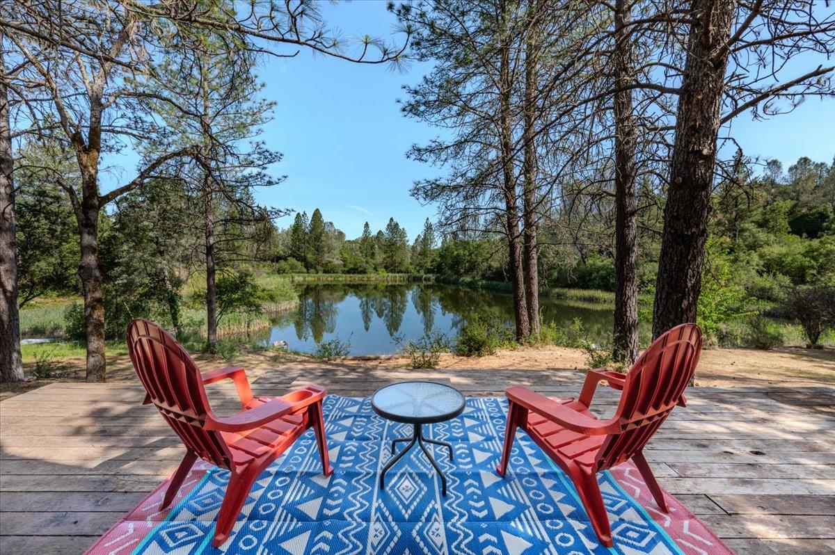 a patio with water view fountain and a table and chairs