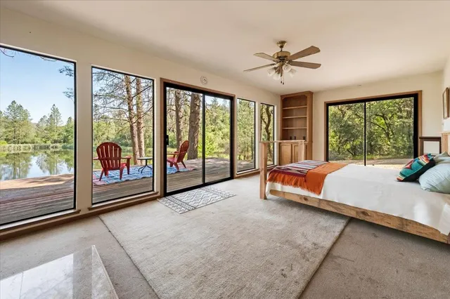 a bed sitting in a bedroom next to a large window