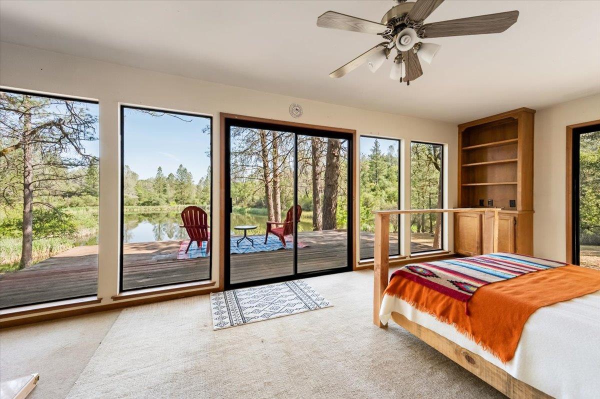 11076 Houghton Ranch Road Penn Valley, CA 95946 - Photo 14 of 41 a spacious bedroom with a bed and glass door