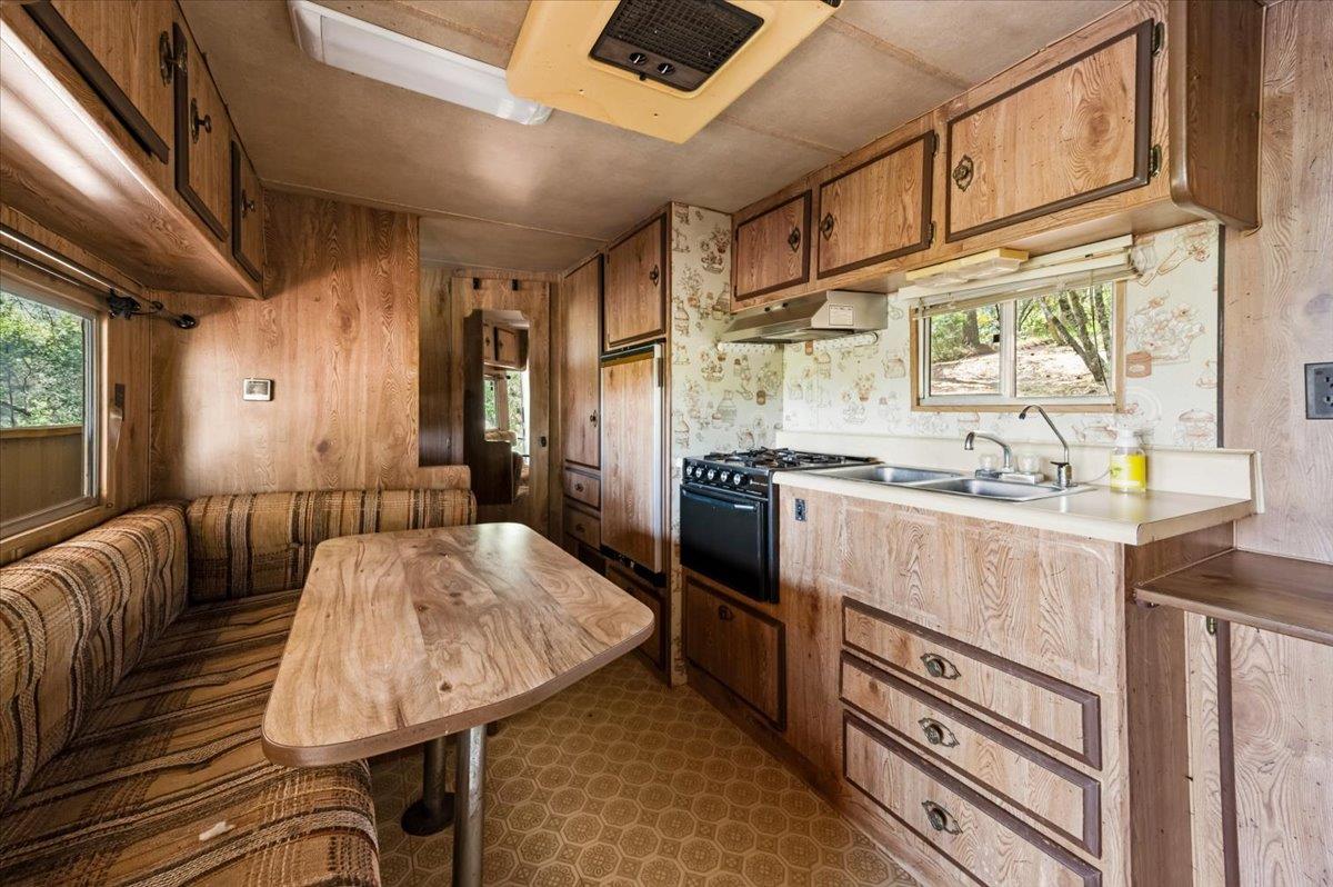 11076 Houghton Ranch Road Penn Valley, CA 95946 - Photo 15 of 41 a kitchen with stainless steel appliances granite countertop a sink a stove and a refrigerator