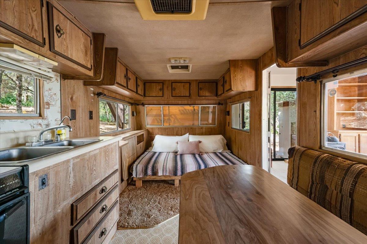11076 Houghton Ranch Road Penn Valley, CA 95946 - Photo 16 of 41 a view of a kitchen with furniture and a window