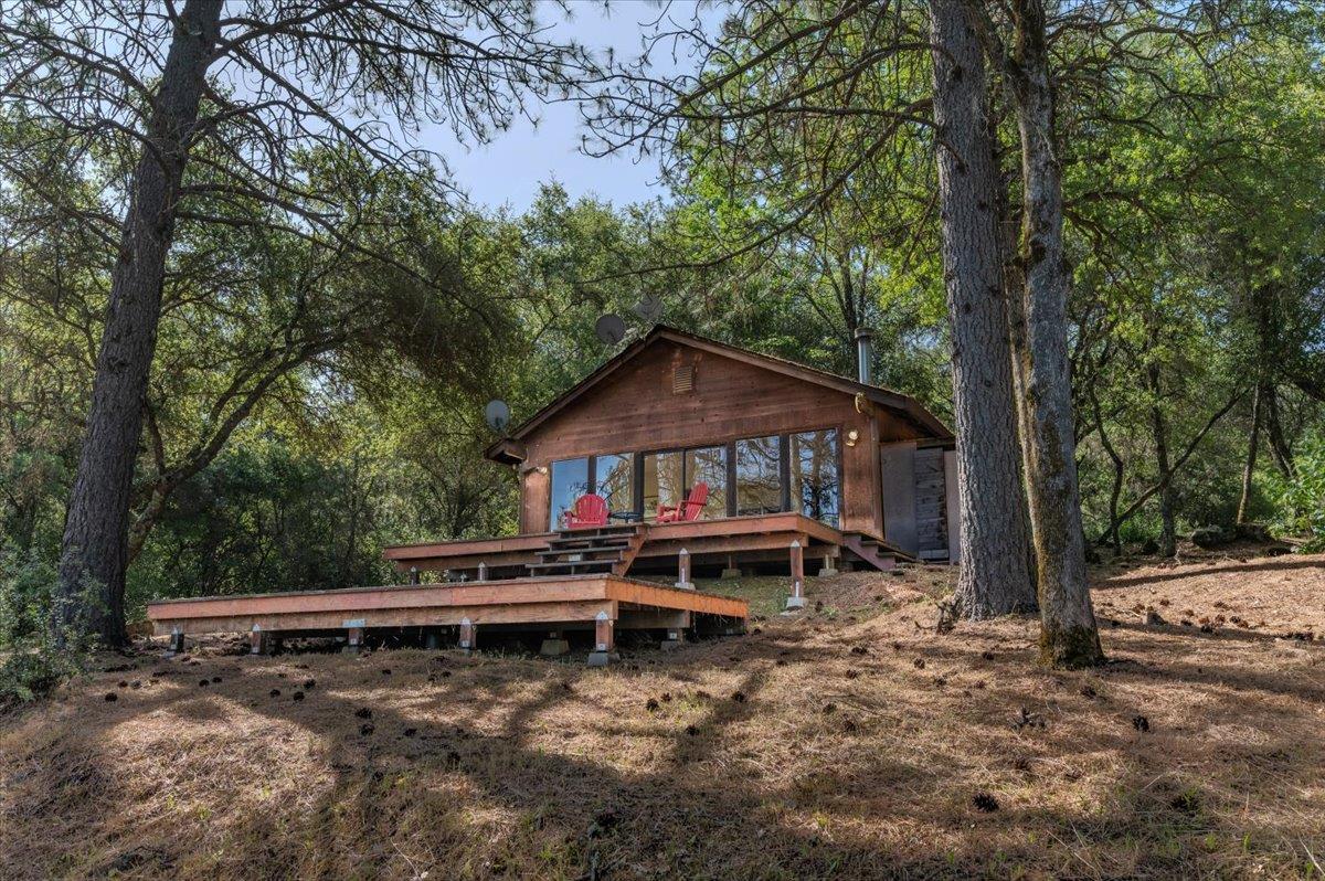 11076 Houghton Ranch Road Penn Valley, CA 95946 - Photo 19 of 41 a view of a house with a yard and large trees