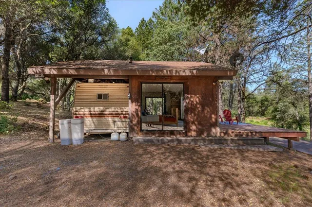 a view of a chairs and table in a back yard