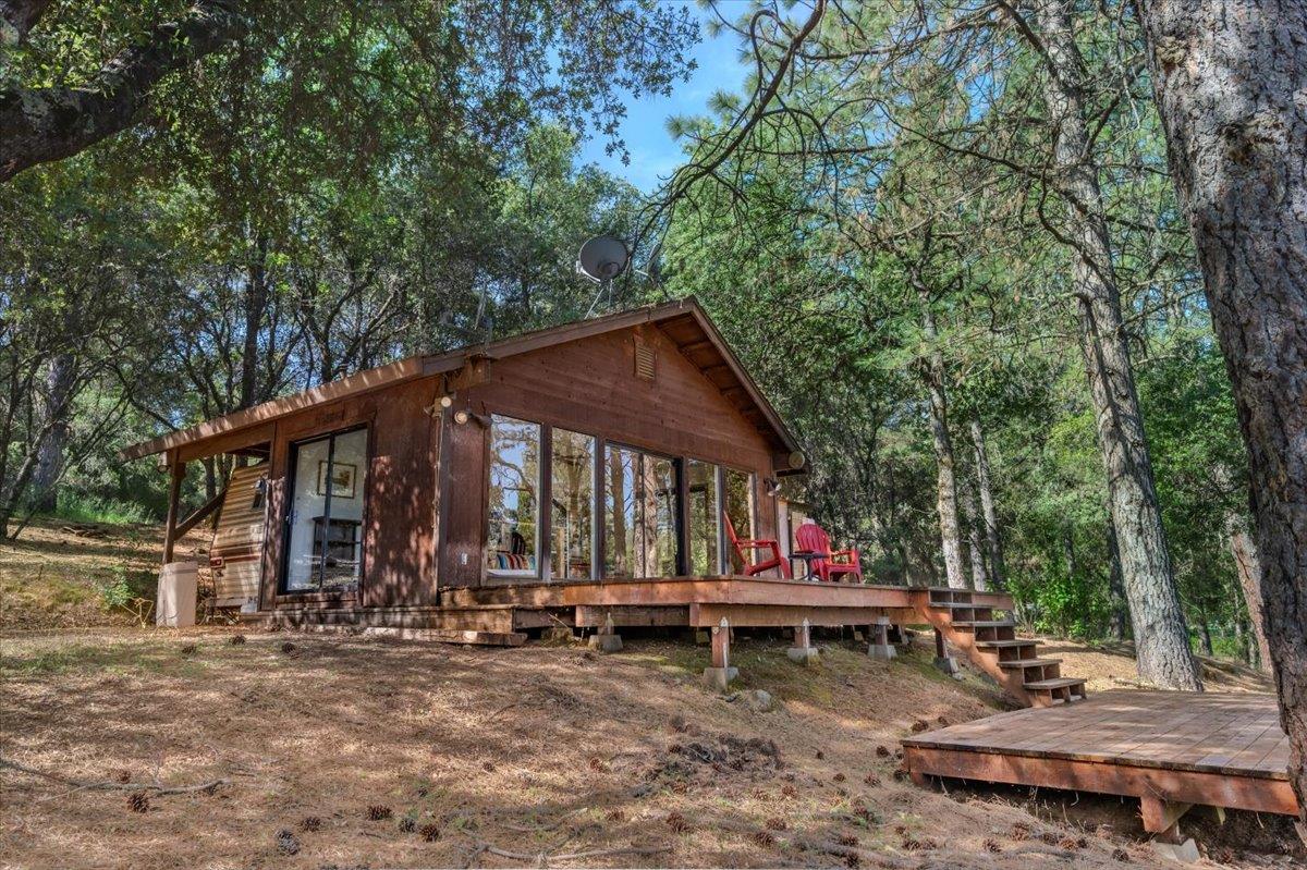 11076 Houghton Ranch Road Penn Valley, CA 95946 - Photo 5 of 41 a backyard of a house with table and chairs