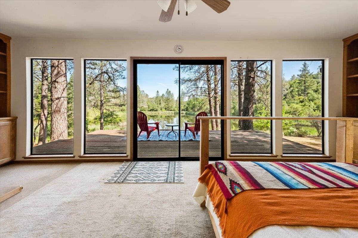 11076 Houghton Ranch Road Penn Valley, CA 95946 - Photo 7 of 41 a bedroom with a large bed and a large window