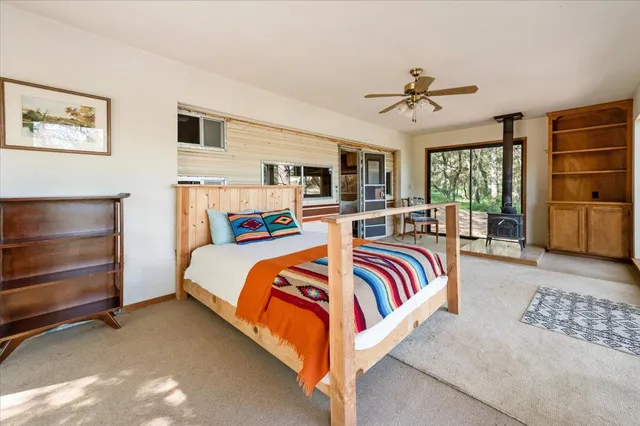 a bedroom with a large bed and a chandelier