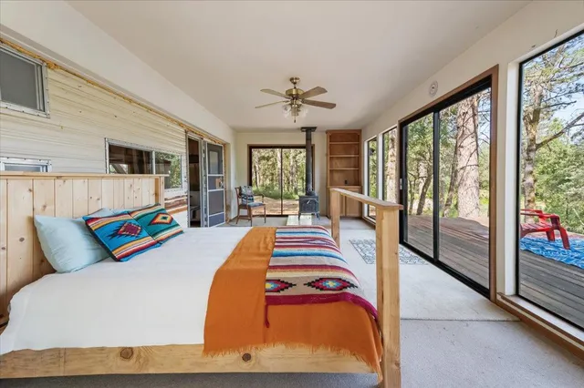 a bed sitting in a bedroom next to a large window