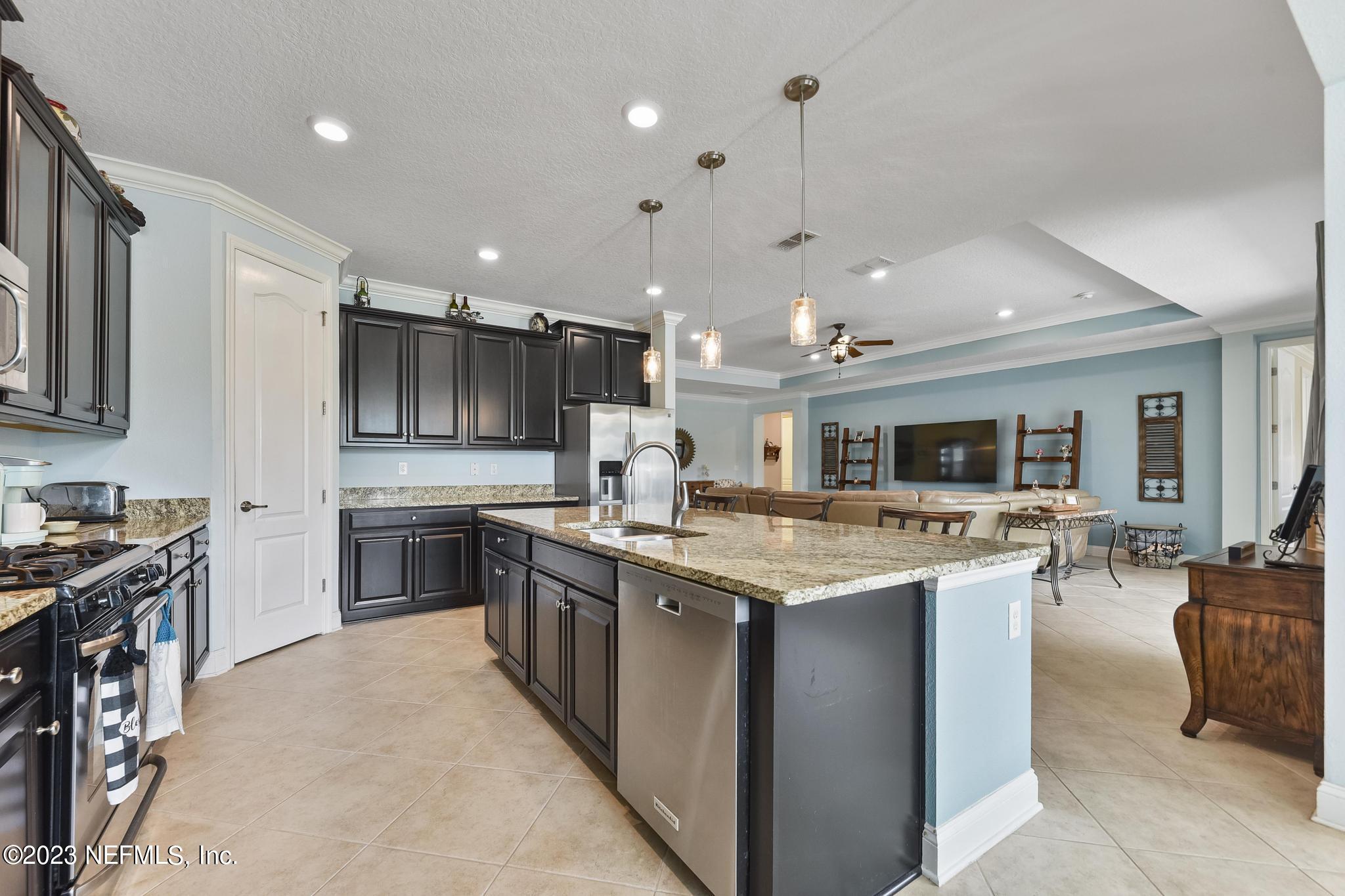 168 St Kitts Loop St. Augustine, FL 32092 - Photo 11 of 41 a kitchen with stainless steel appliances granite countertop a sink and a stove