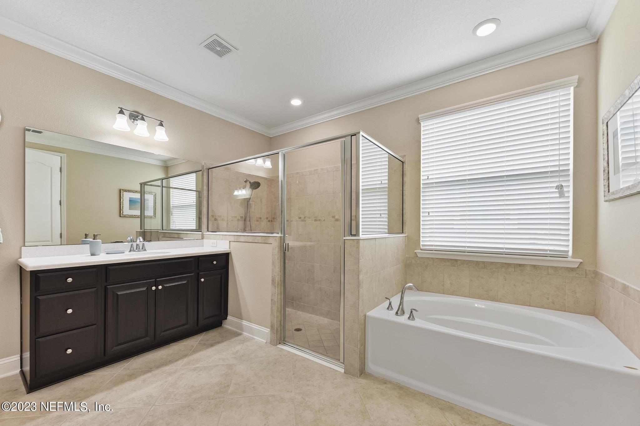 168 St Kitts Loop St. Augustine, FL 32092 - Photo 16 of 41 a spacious bathroom with a tub sink shower and mirror