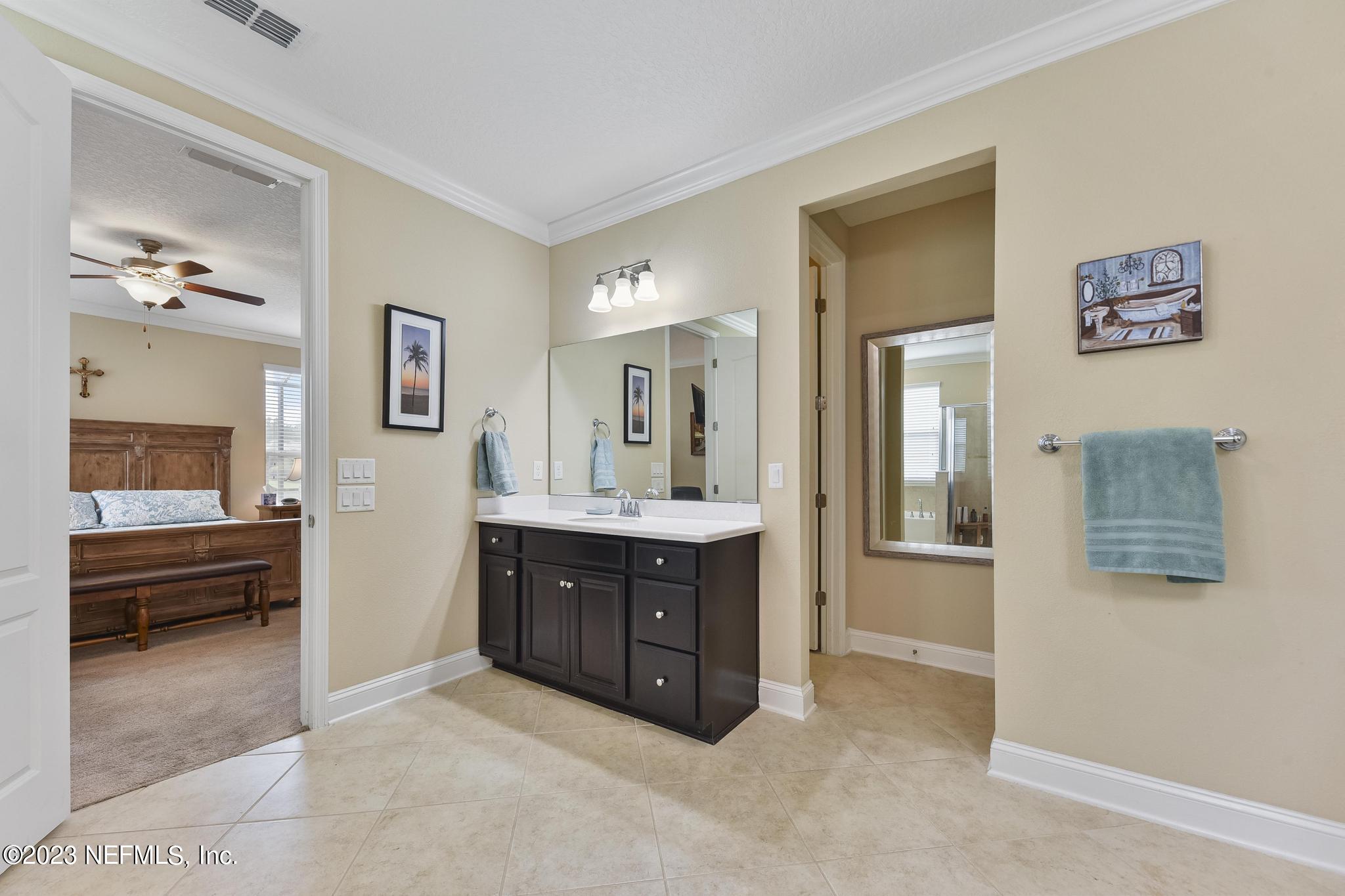 168 St Kitts Loop St. Augustine, FL 32092 - Photo 17 of 41 a spacious bedroom with a bed and a view of bathroom