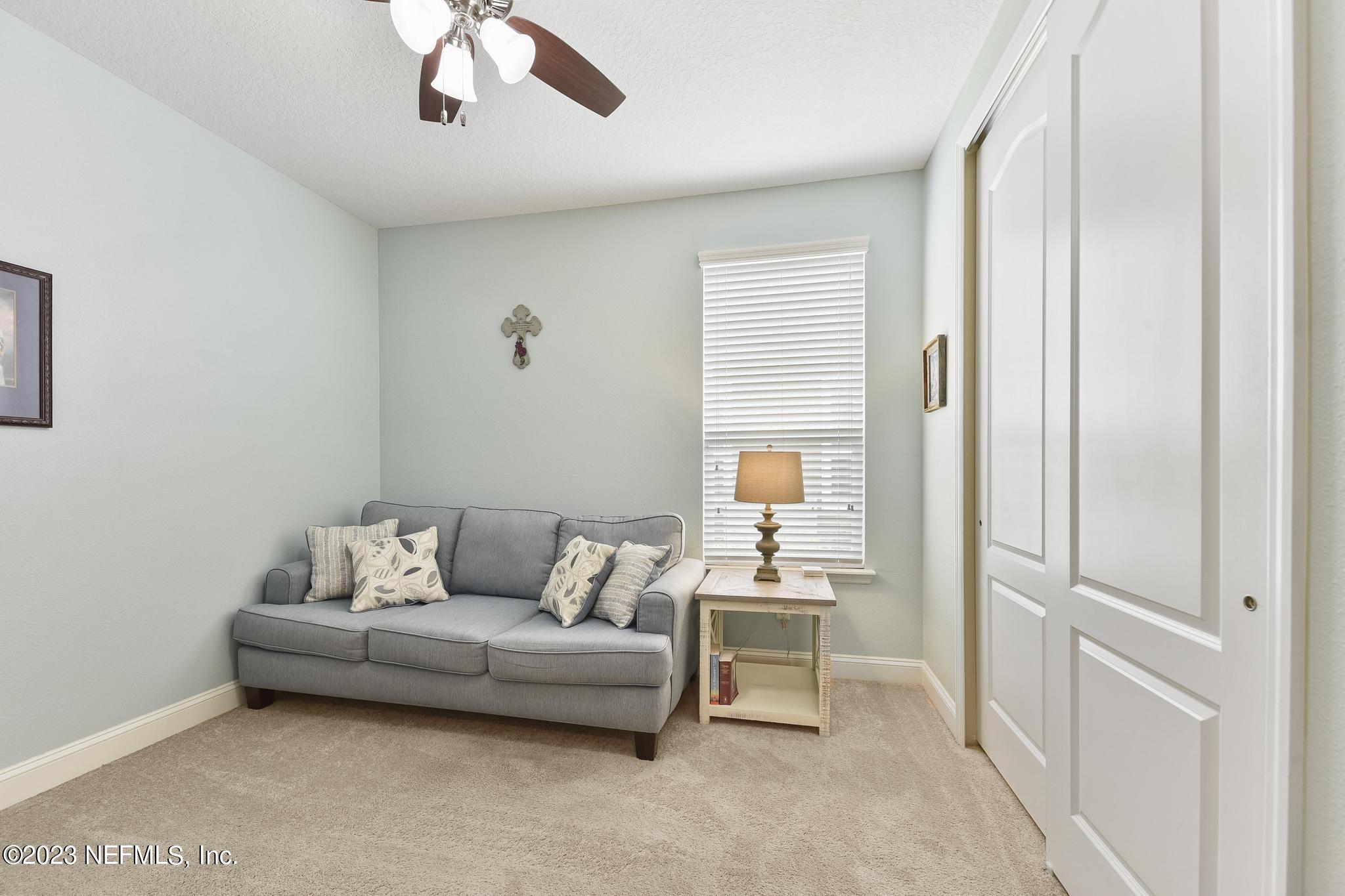 168 St Kitts Loop St. Augustine, FL 32092 - Photo 18 of 41 a living room with furniture and a wooden floor