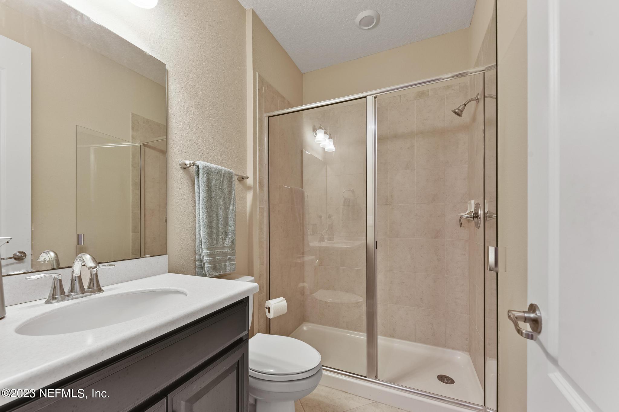 168 St Kitts Loop St. Augustine, FL 32092 - Photo 19 of 41 a bathroom with a sink a toilet and shower