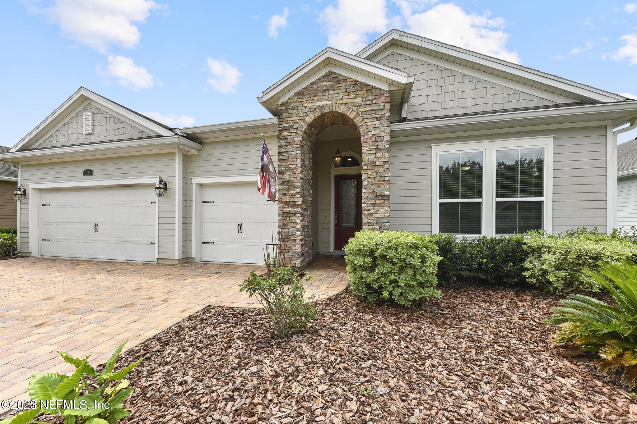 168 St Kitts Loop St. Augustine, FL 32092 - Photo 2 of 41 a front view of a house with garden