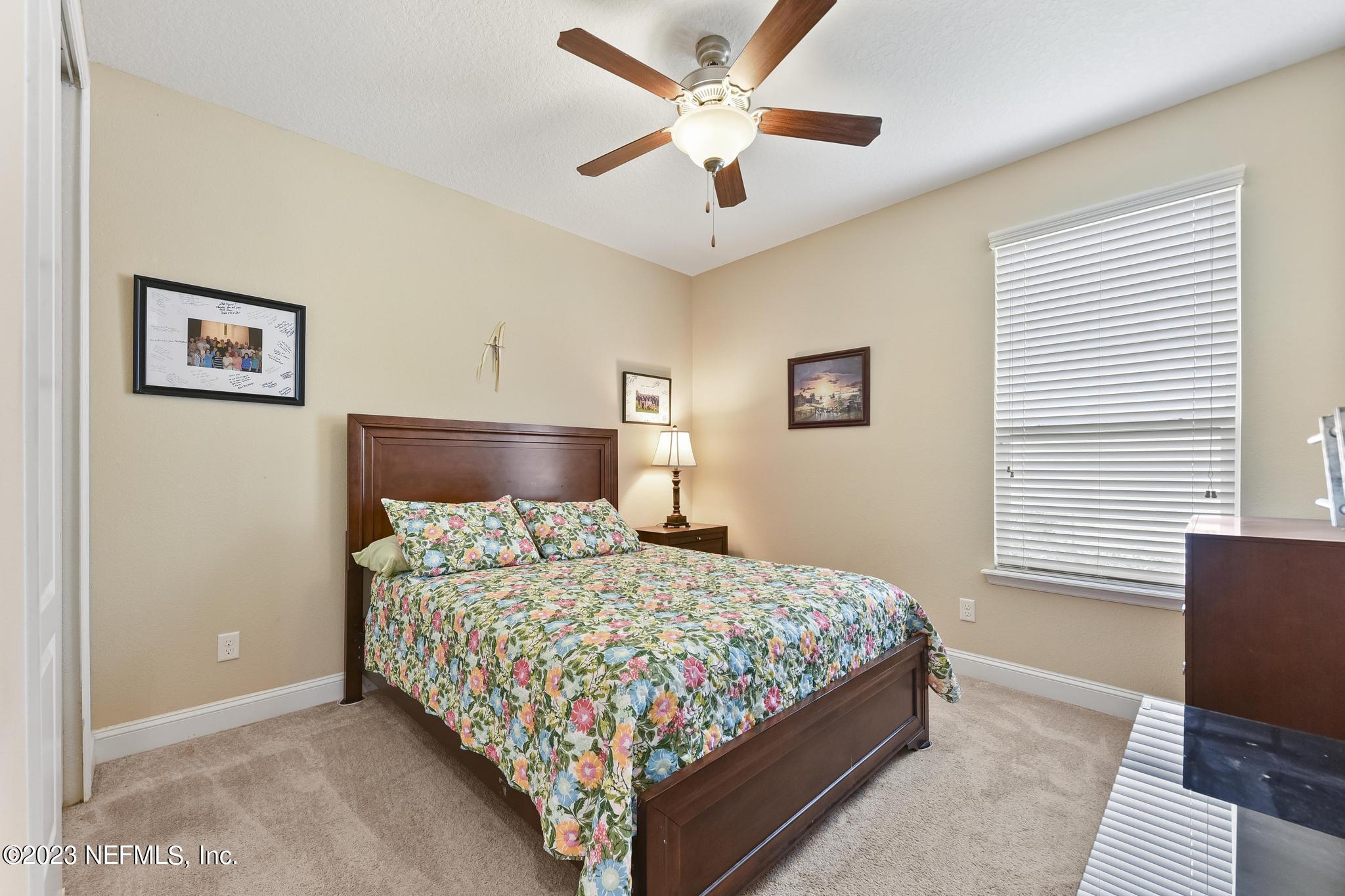 168 St Kitts Loop St. Augustine, FL 32092 - Photo 21 of 41 a bedroom with a bed and window