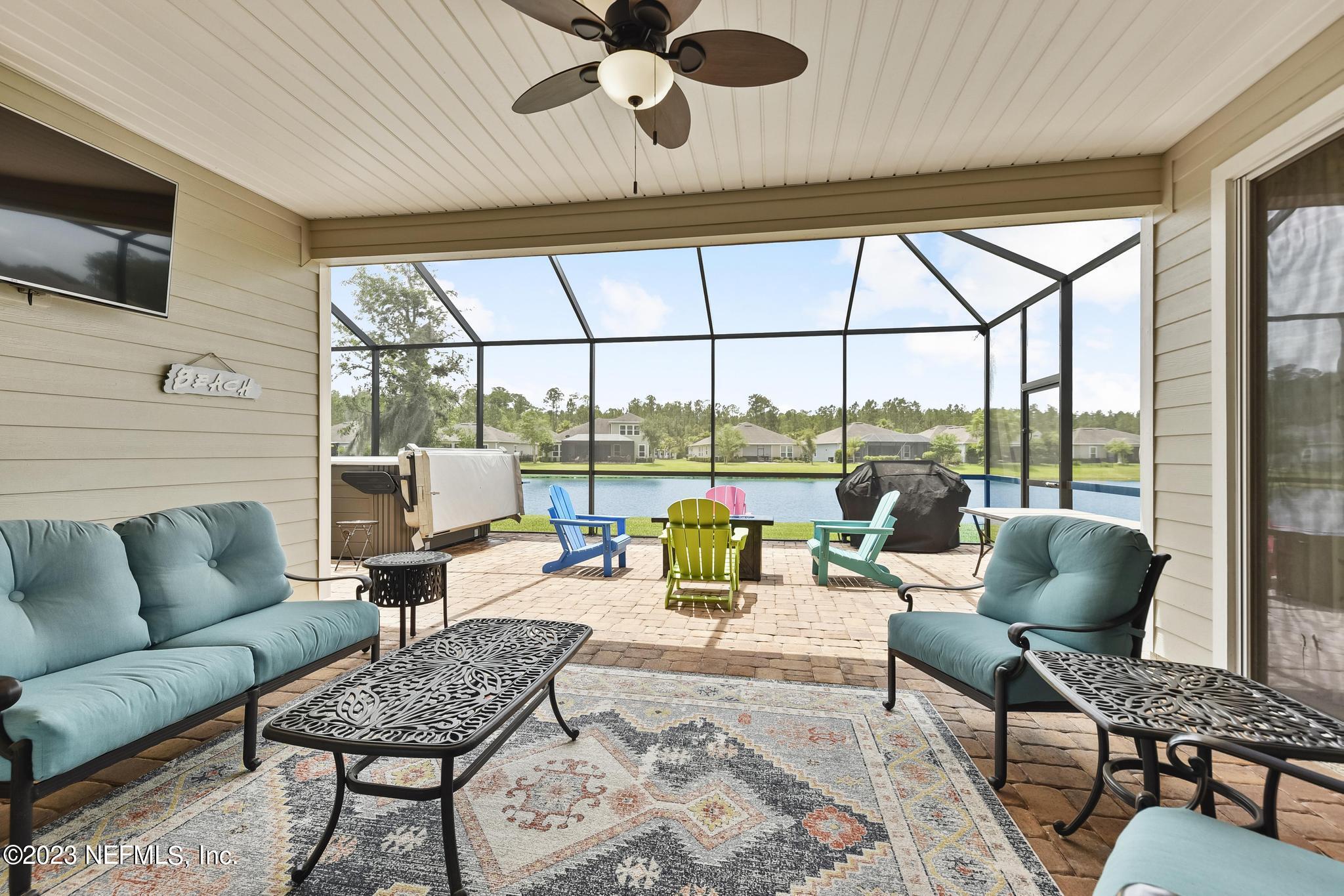 168 St Kitts Loop St. Augustine, FL 32092 - Photo 24 of 41 a living room with furniture and a floor to ceiling window