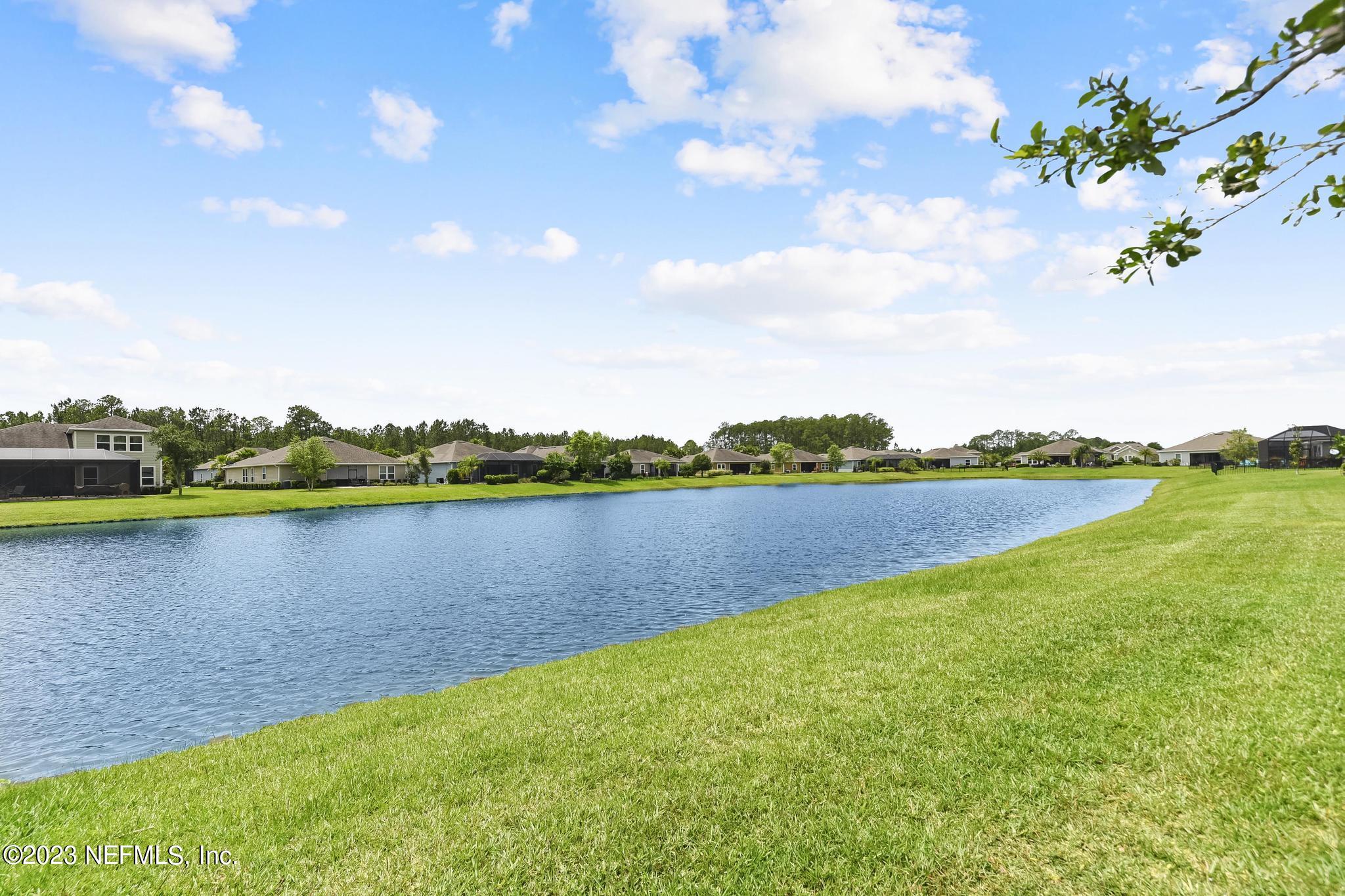168 St Kitts Loop St. Augustine, FL 32092 - Photo 30 of 41 a view of a lake with houses in the back