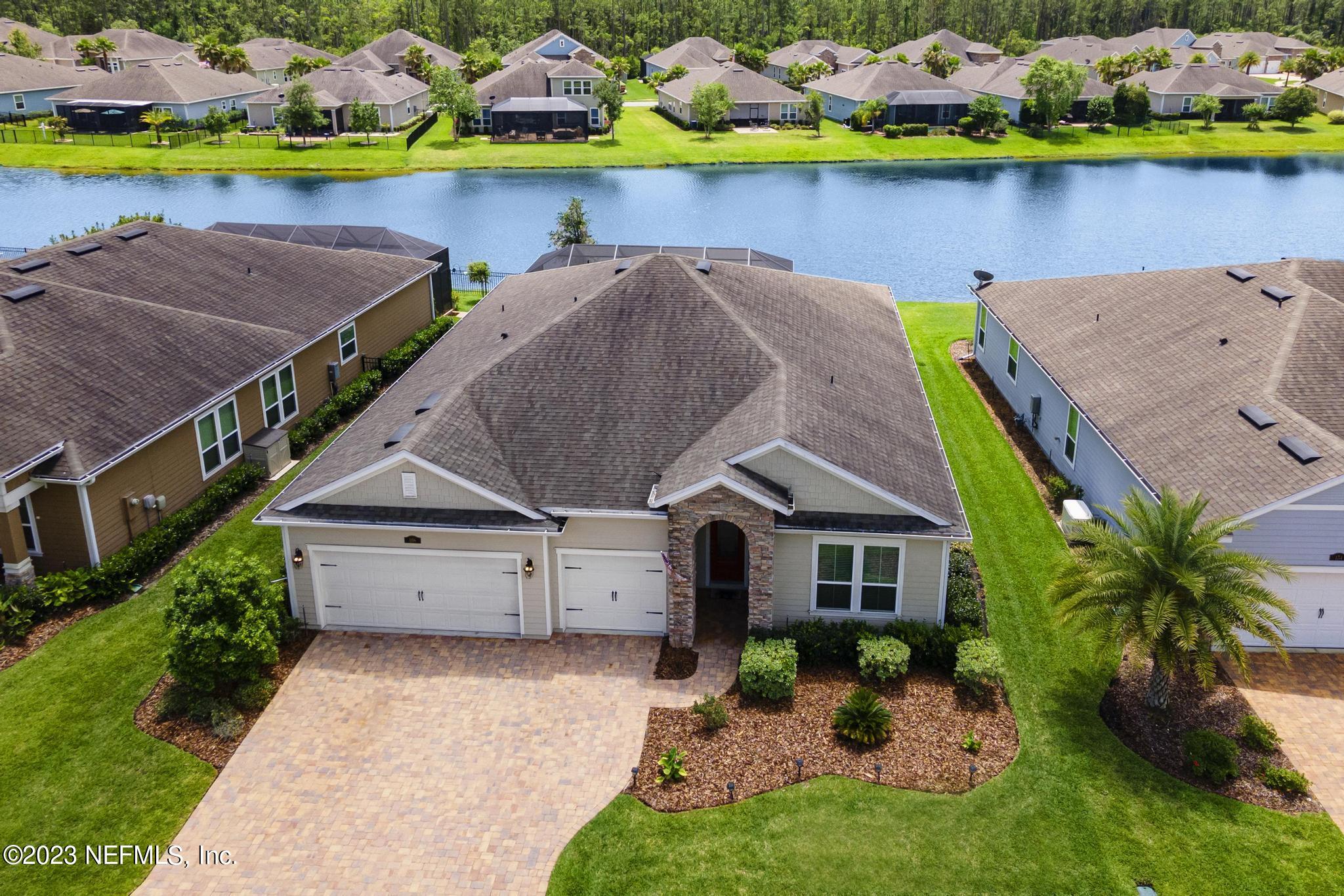 168 St Kitts Loop St. Augustine, FL 32092 - Photo 34 of 41 a aerial view of a house with a garden and lake view