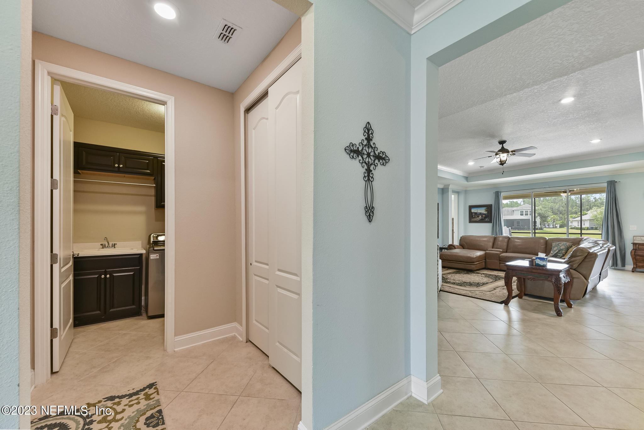 168 St Kitts Loop St. Augustine, FL 32092 - Photo 5 of 41 a view of a livingroom with furniture cabinet and a rug