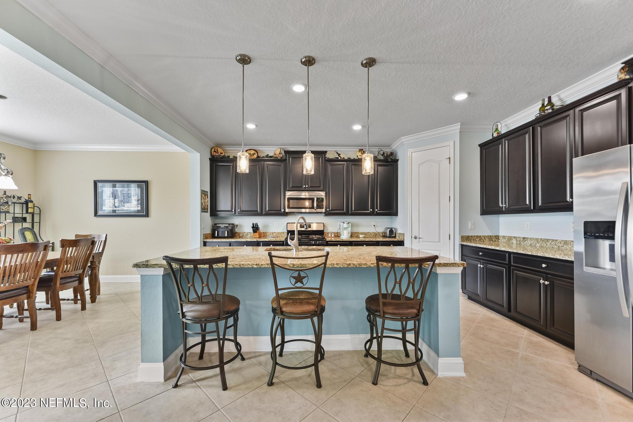 168 St Kitts Loop St. Augustine, FL 32092 - Photo 9 of 41 a large kitchen with a table and chairs
