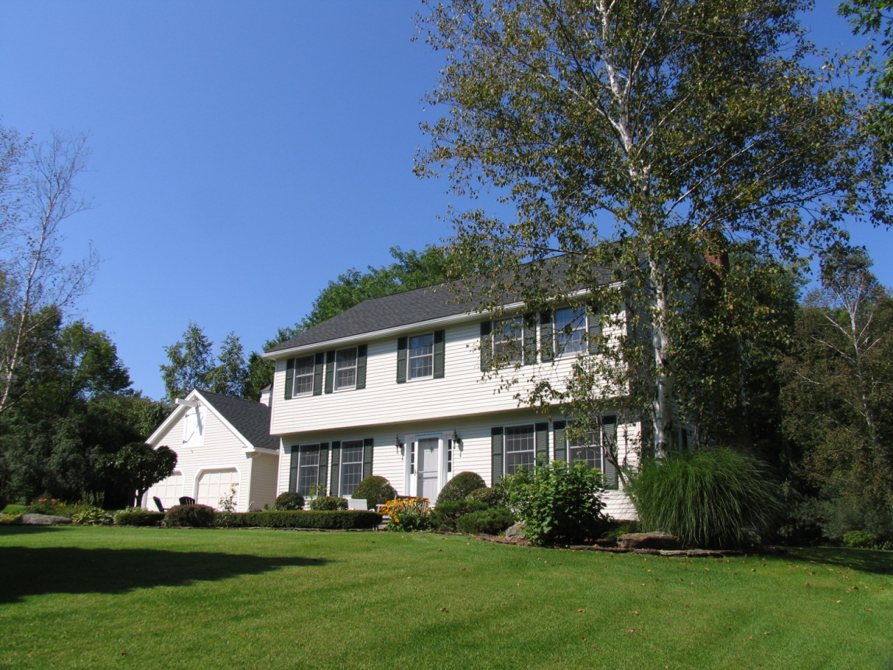 31 Old Barn Road Lenox, MA 01240 - Photo 2 of 56 a front view of a house with a garden and trees