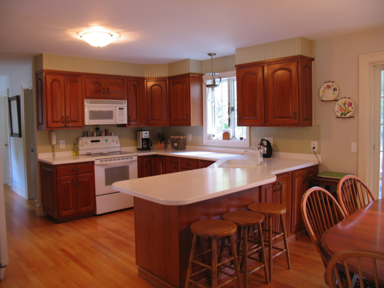 31 Old Barn Road Lenox, MA 01240 - Photo 20 of 56 a kitchen with stainless steel appliances kitchen island granite countertop a sink a stove a dining table and chairs